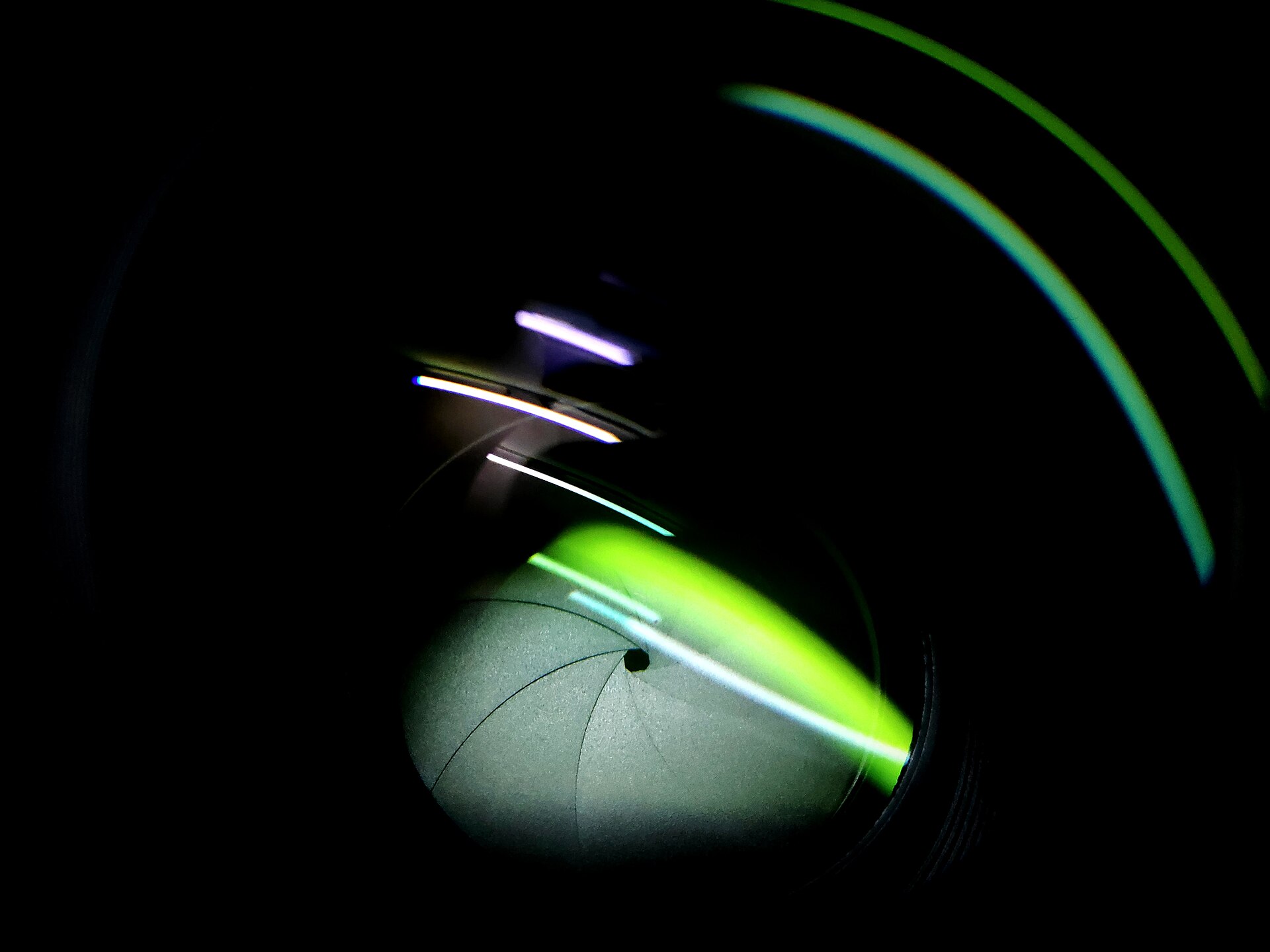 Aperture blades in a camera lens forming a wide circular opening