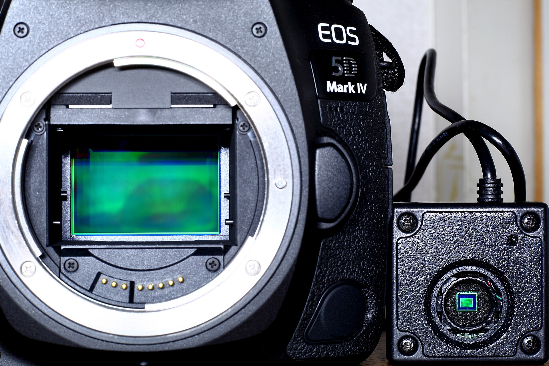 Size comparison between a large 35mm-class CMOS sensor and a small mobile image sensor