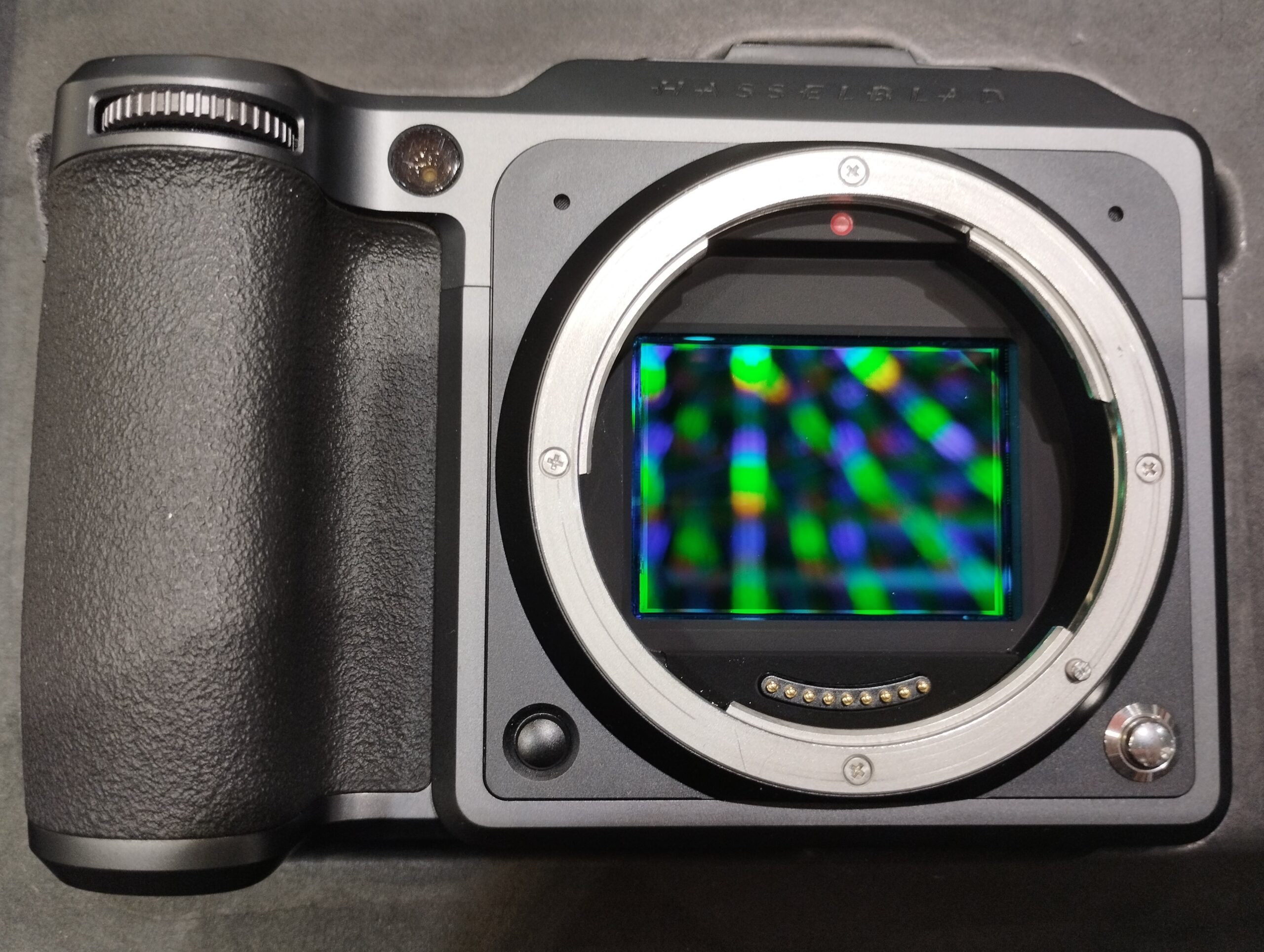 Medium format camera sensor compared to a lens, illustrating the larger 44 x 33 mm imaging area
