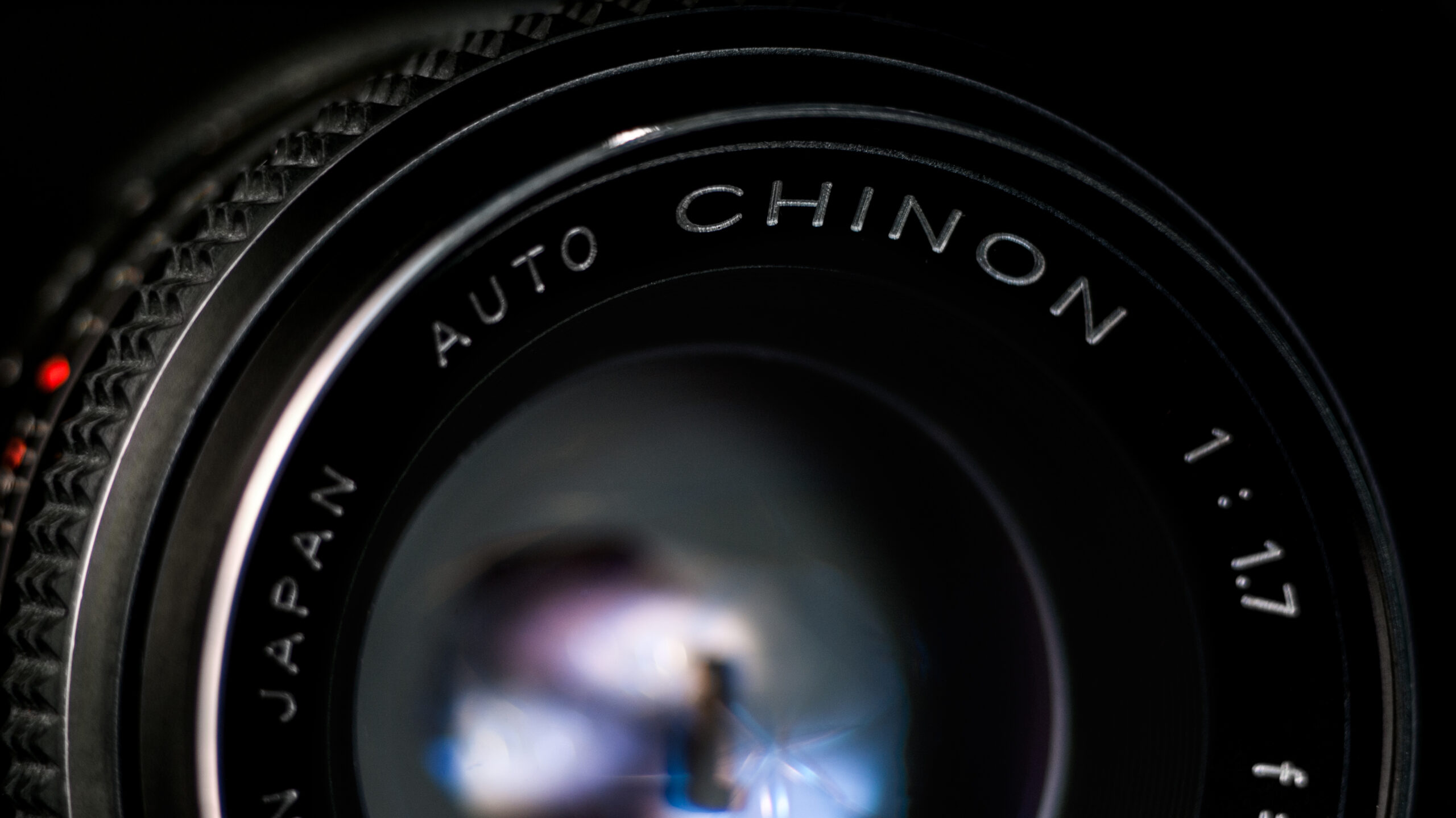 Vintage manual focus camera lens with visible focus ring