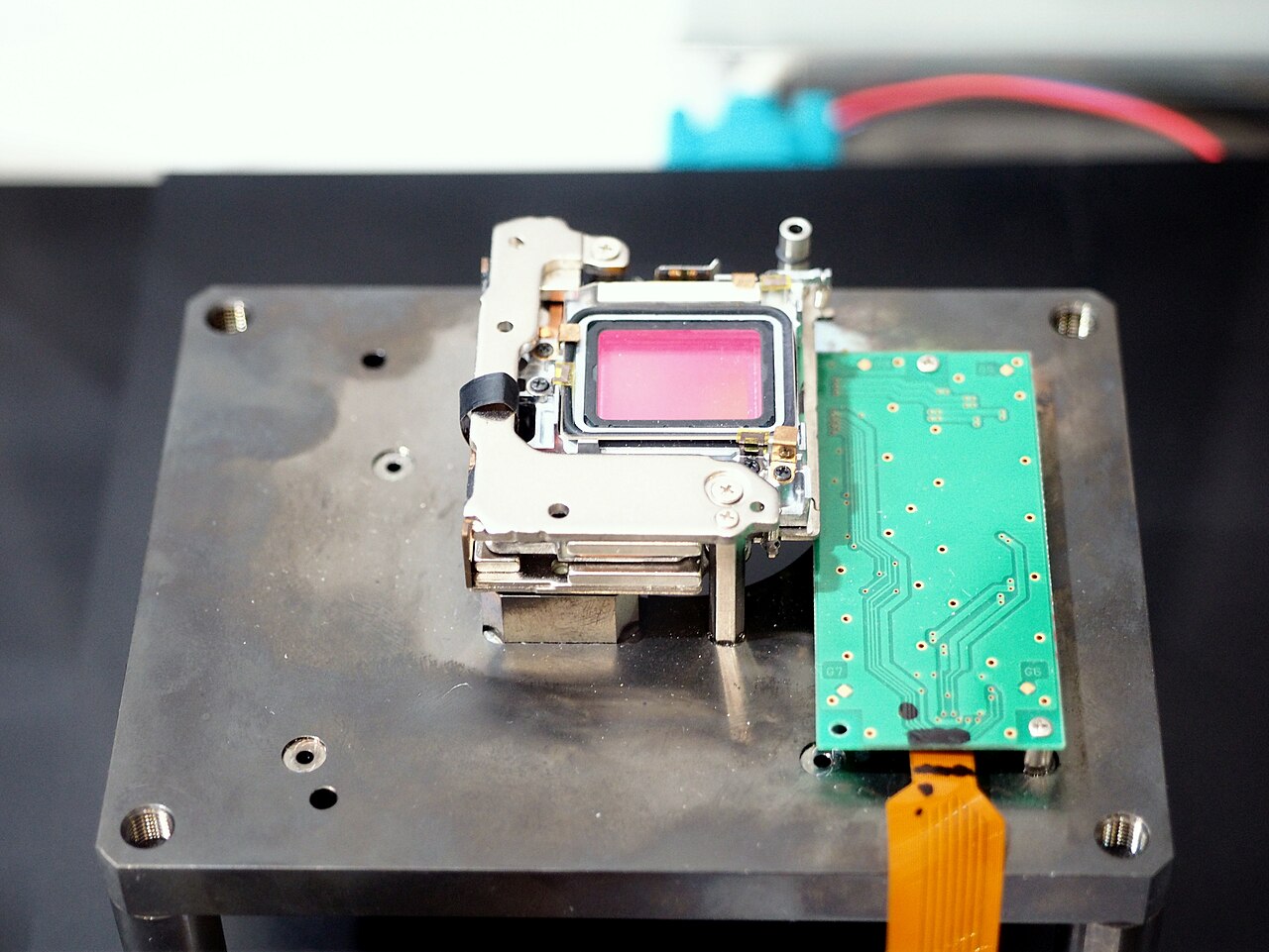 The 5-axis image stabilization unit of an Olympus OM-D E-M1 camera