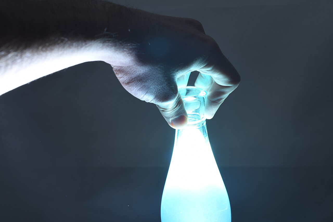 A speedlight flash firing from behind a subject